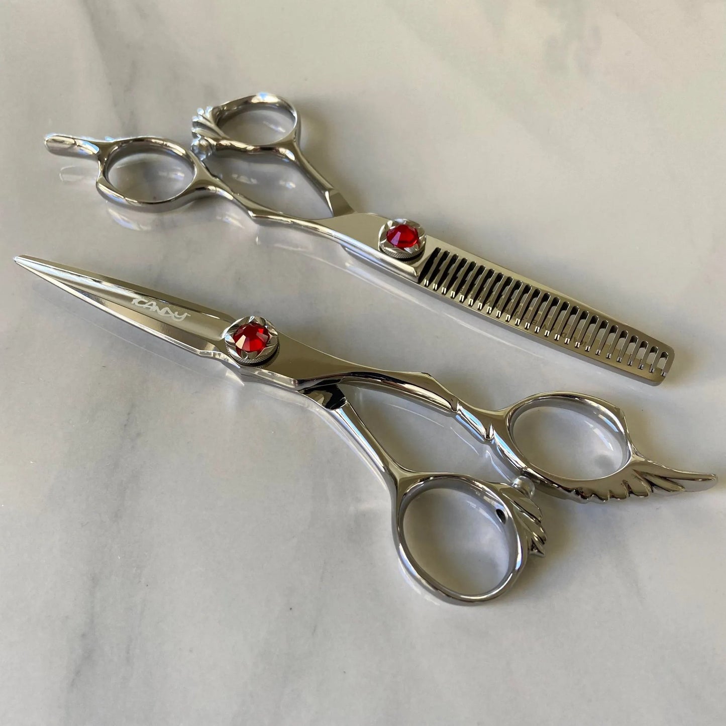 iCandy ANGEL Ice Ruby VG10 professional hairdressing scissors and thinning scissors bundle featuring premium Japanese VG10 steel, ergonomic offset handles, precision convex blades and a distinctive ruby red diamanté tension screw for smooth cutting and controlled texturising.