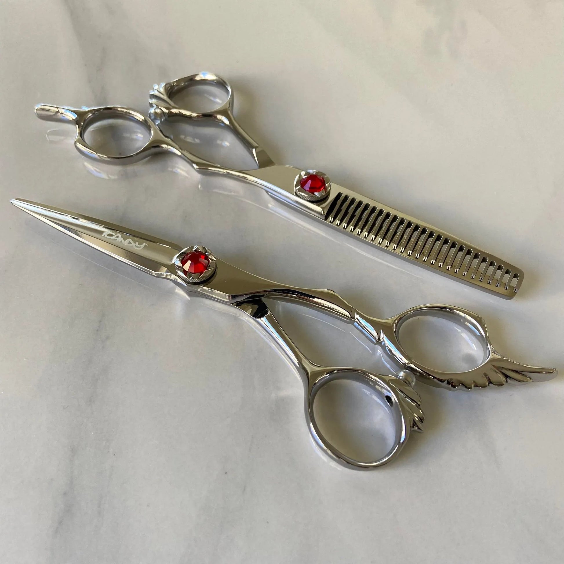 iCandy ANGEL Ice Ruby VG10 professional hairdressing scissors and thinning scissors bundle featuring premium Japanese VG10 steel, ergonomic offset handles, precision convex blades and a distinctive ruby red diamanté tension screw for smooth cutting and controlled texturising.
