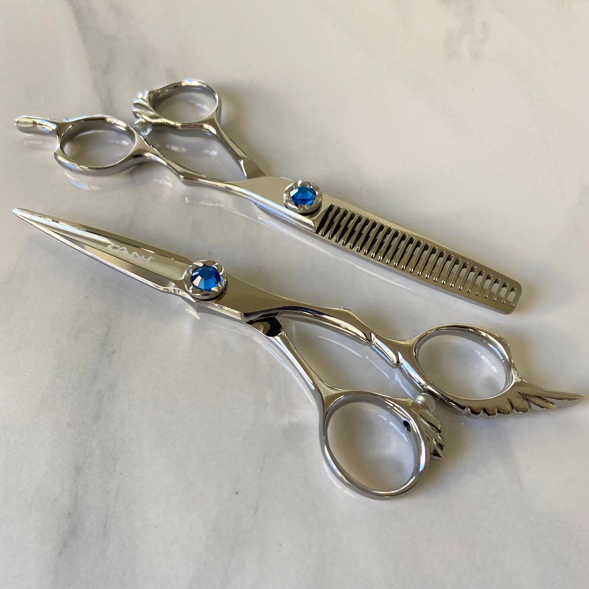 iCandy ANGEL Ice Blue VG10 professional hairdressing scissors and thinning scissors bundle featuring premium Japanese VG10 steel, ergonomic offset handles, precision convex blades and a distinctive ice blue diamanté tension screw for smooth cutting and controlled texturising.
